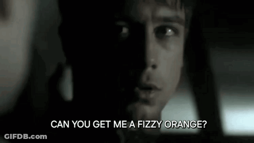 A Close Up Of A Man 'S Face With The Words `` Can You Get Me A Fizzy Orange ? '' Written Below Him . GIF