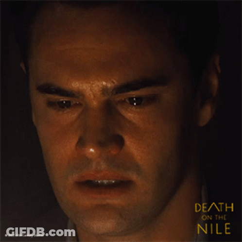 A Close Up Of A Man 'S Face With The Words Death On The Nile Above Him GIF