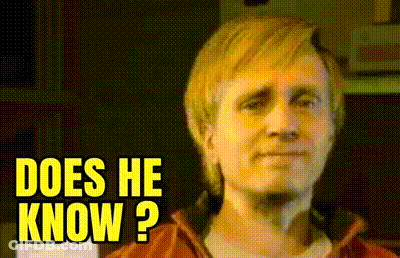 A Close Up Of A Man 'S Face With The Words " Does He Know " Above Him GIF