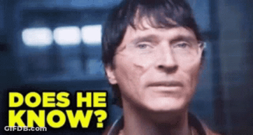 A Close Up Of A Man 'S Face With The Words Does He Know Above Him GIF