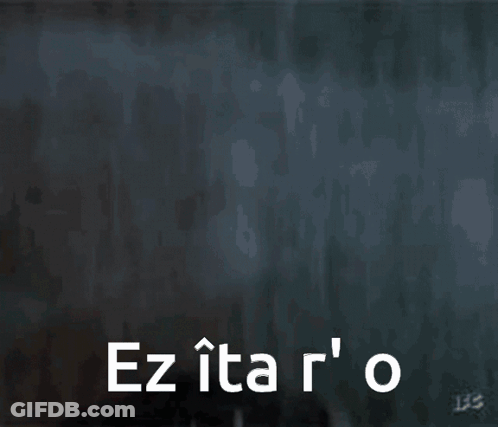 A Close Up Of A Man 'S Face With The Words Ez Ita R ' O GIF
