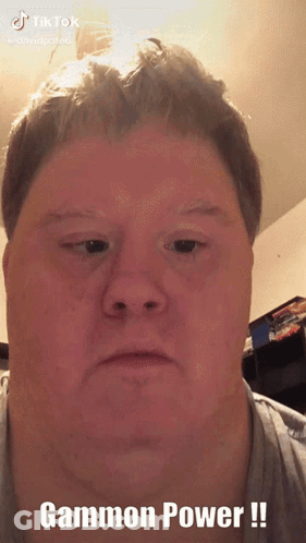 A Close Up Of A Man 'S Face With The Words Gammon Power Written Below It GIF