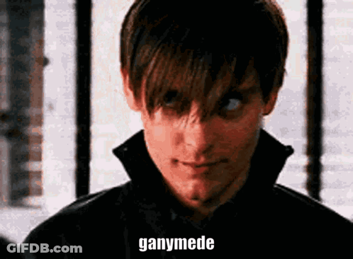 A Close Up Of A Man 'S Face With The Words Ganymede Written On His Face . GIF