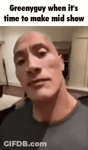 A Close Up Of A Man 'S Face With The Words Greenyguy When It 'S Time To Make Mid Show GIF