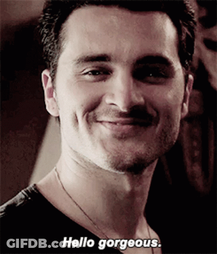 A Close Up Of A Man 'S Face With The Words Hello Gorgeous On The Bottom GIF
