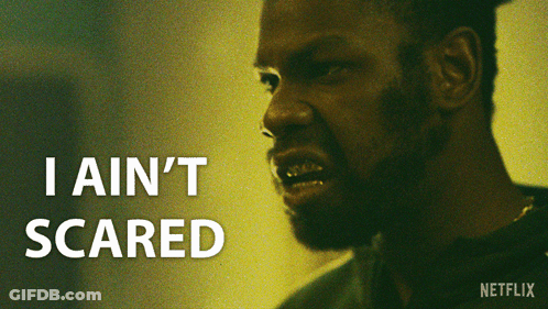 A Close Up Of A Man 'S Face With The Words " I Ain 'T Scared " Above Him GIF