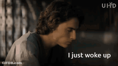 A Close Up Of A Man 'S Face With The Words I Just Woke Up Below Him GIF