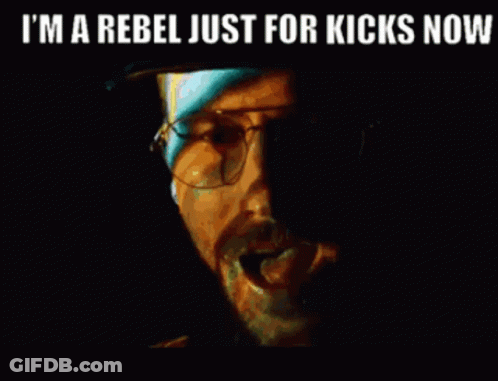 A Close Up Of A Man 'S Face With The Words `` I 'M A Rebel Just For Kicks Now '' . GIF