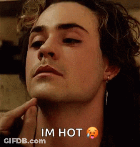 A Close Up Of A Man 'S Face With The Words `` I 'M Hot '' Written On The Bottom . GIF