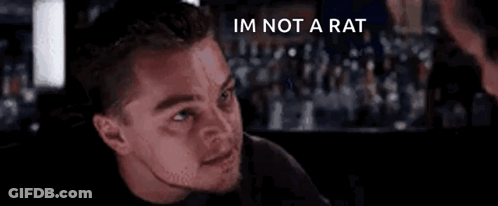 A Close Up Of A Man 'S Face With The Words `` I 'M Not A Rat '' Written On It . GIF