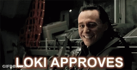 A Close Up Of A Man 'S Face With The Words `` Loki Approves '' Written Above Him . GIF
