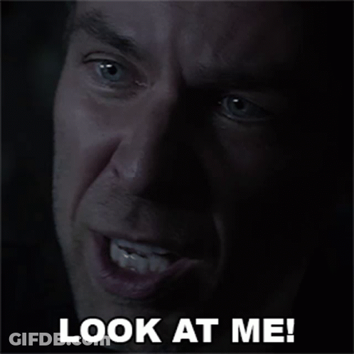 A Close Up Of A Man 'S Face With The Words Look At Me GIF