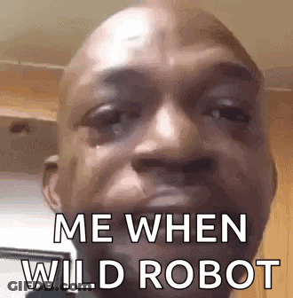A Close Up Of A Man 'S Face With The Words `` Me When Wild Robot '' On It . GIF