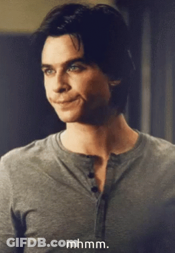 A Close Up Of A Man 'S Face With The Words Mhmm Written Below Him GIF
