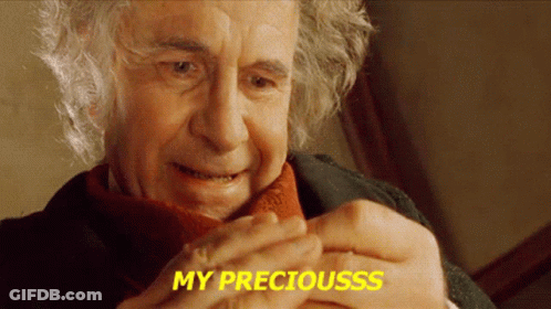 A Close Up Of A Man 'S Face With The Words My Preciousss Written In Yellow GIF