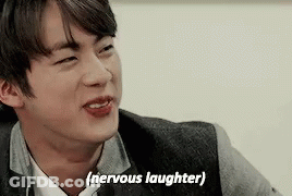 A Close Up Of A Man 'S Face With The Words `` Nervous Laughter '' Written Next To Him . GIF