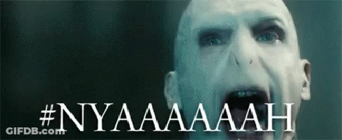 A Close Up Of A Man 'S Face With The Words Nyaaaaah Written On It . GIF