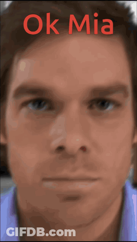 A Close Up Of A Man 'S Face With The Words Ok Mia Written Above It GIF