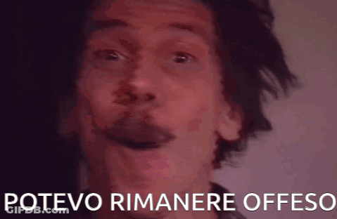 A Close Up Of A Man 'S Face With The Words Potevo Rimanere Offeso Written Below Him GIF
