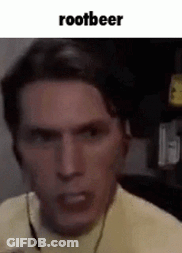 A Close Up Of A Man 'S Face With The Words `` Rootbeer '' Written Above Him . GIF