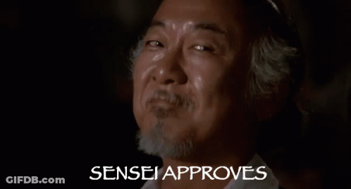 A Close Up Of A Man 'S Face With The Words Sensei Approves Behind Him . GIF