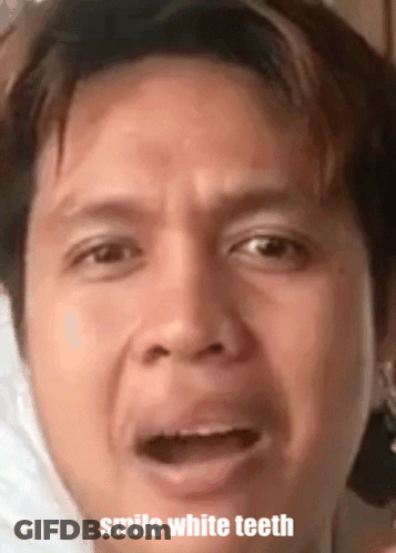 A Close Up Of A Man 'S Face With The Words Smile White Teeth GIF
