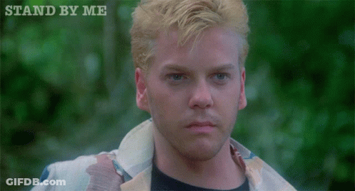 A Close Up Of A Man 'S Face With The Words " Stand By Me " Above Him GIF