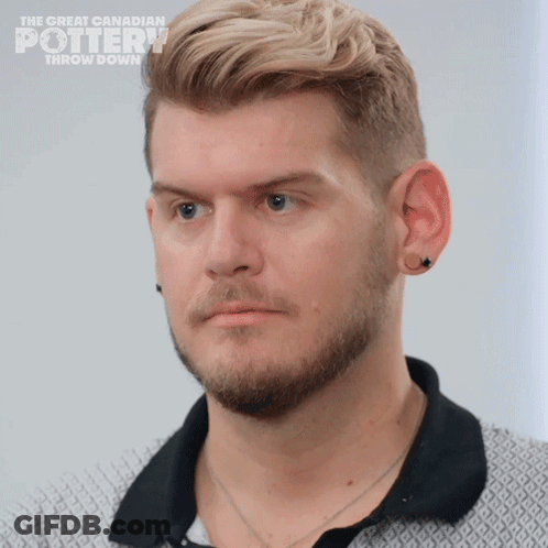 A Close Up Of A Man 'S Face With The Words The Great Canadian Pottery Throw Down On The Bottom GIF