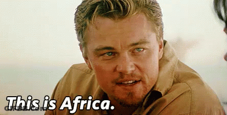 A Close Up Of A Man 'S Face With The Words `` This Is Africa '' Written Below Him . GIF
