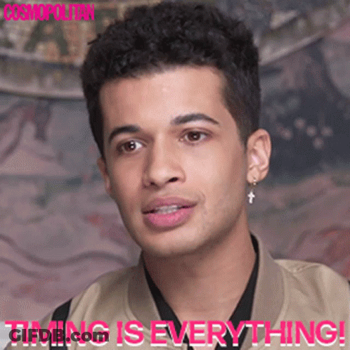 A Close Up Of A Man 'S Face With The Words " Timing Is Everything " Below Him GIF