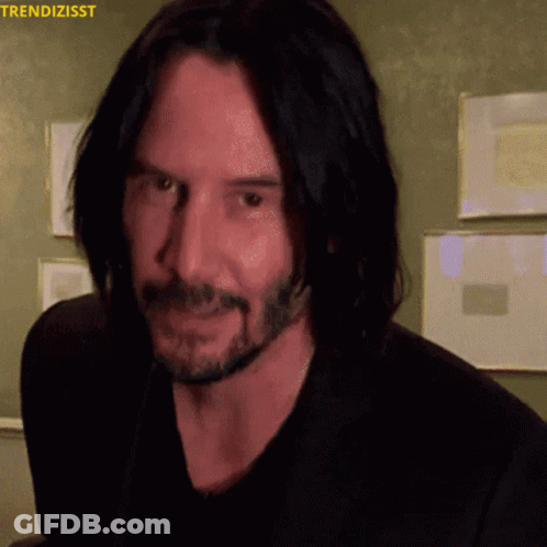 A Close Up Of A Man 'S Face With The Words Trendizisst On The Top GIF