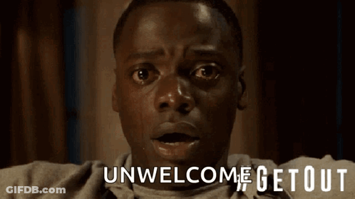 A Close Up Of A Man 'S Face With The Words Unwelcome Getout Above Him GIF