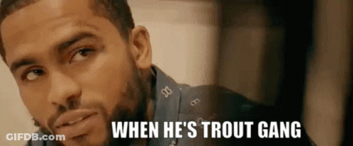 A Close Up Of A Man 'S Face With The Words `` When He 'S Trout Gang '' Written On The Bottom . GIF