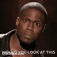 A Close Up Of A Man 'S Face With The Words `` Would You Look At This '' . GIF