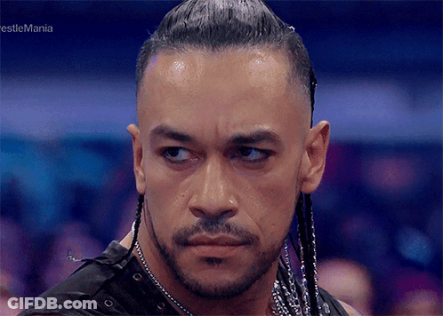 A Close Up Of A Man 'S Face With The Words Wrestlemania In The Corner GIF