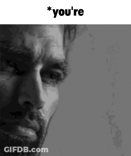 A Close Up Of A Man 'S Face With The Words `` You 'Re '' Above Him . GIF