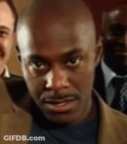 A Close Up Of A Man 'S Face With Three Other Men In The Background GIF