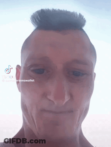 A Close Up Of A Man 'S Face With Tiktok Written On The Bottom Right GIF