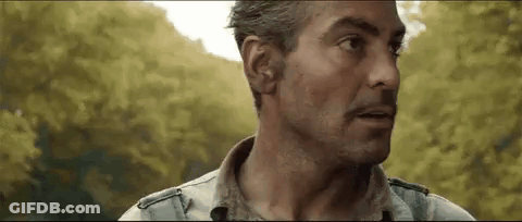 A Close Up Of A Man 'S Face With Trees In The Background And A Blurred Background . GIF