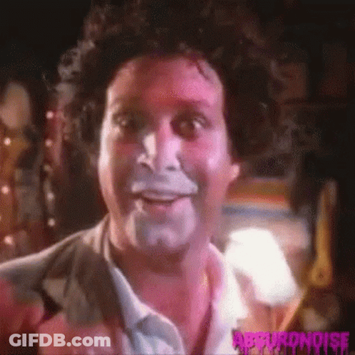 A Close Up Of A Man 'S Face With White Paint On It . GIF