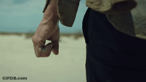 A Close Up Of A Man 'S Hand With A Fist In The Air GIF