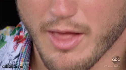 A Close Up Of A Man 'S Mouth With A Beard GIF