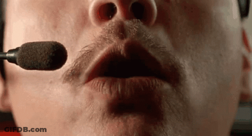 A Close Up Of A Man 'S Mouth With A Microphone In It . GIF
