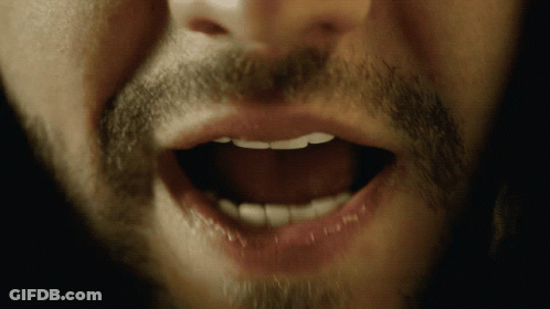A Close Up Of A Man 'S Mouth With His Teeth Visible GIF