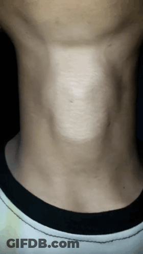 A Close Up Of A Man 'S Neck With A Black Collar GIF
