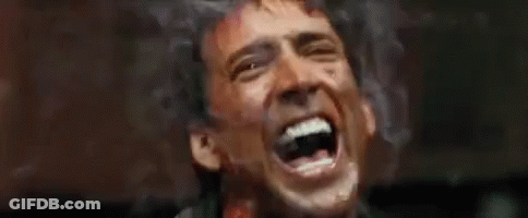 A Close Up Of A Man Screaming With Blood On His Face . GIF