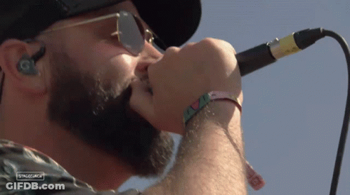 A Close Up Of A Man Singing Into A Microphone With Stagecoach Written On The Bottom Right GIF