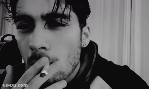 A Close Up Of A Man Smoking A Cigarette GIF
