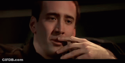 A Close Up Of A Man Smoking A Cigarette In A Car . GIF