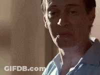 A Close Up Of A Man Smoking A Cigarette In A Room . GIF